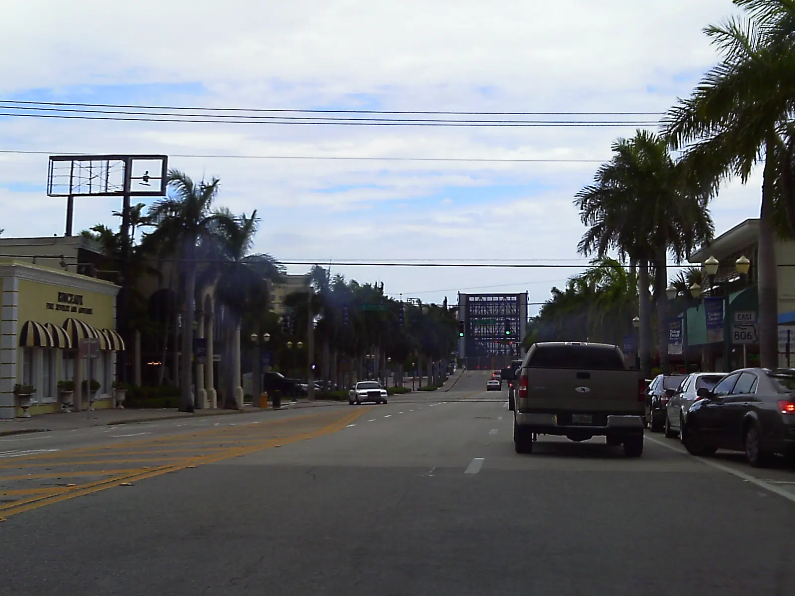 Florida State Road 806 (Atlantic Avenue) heading through downtown Delray Beach, Florida. The drawbridge over the Intercoastal Waterway is in the open position.